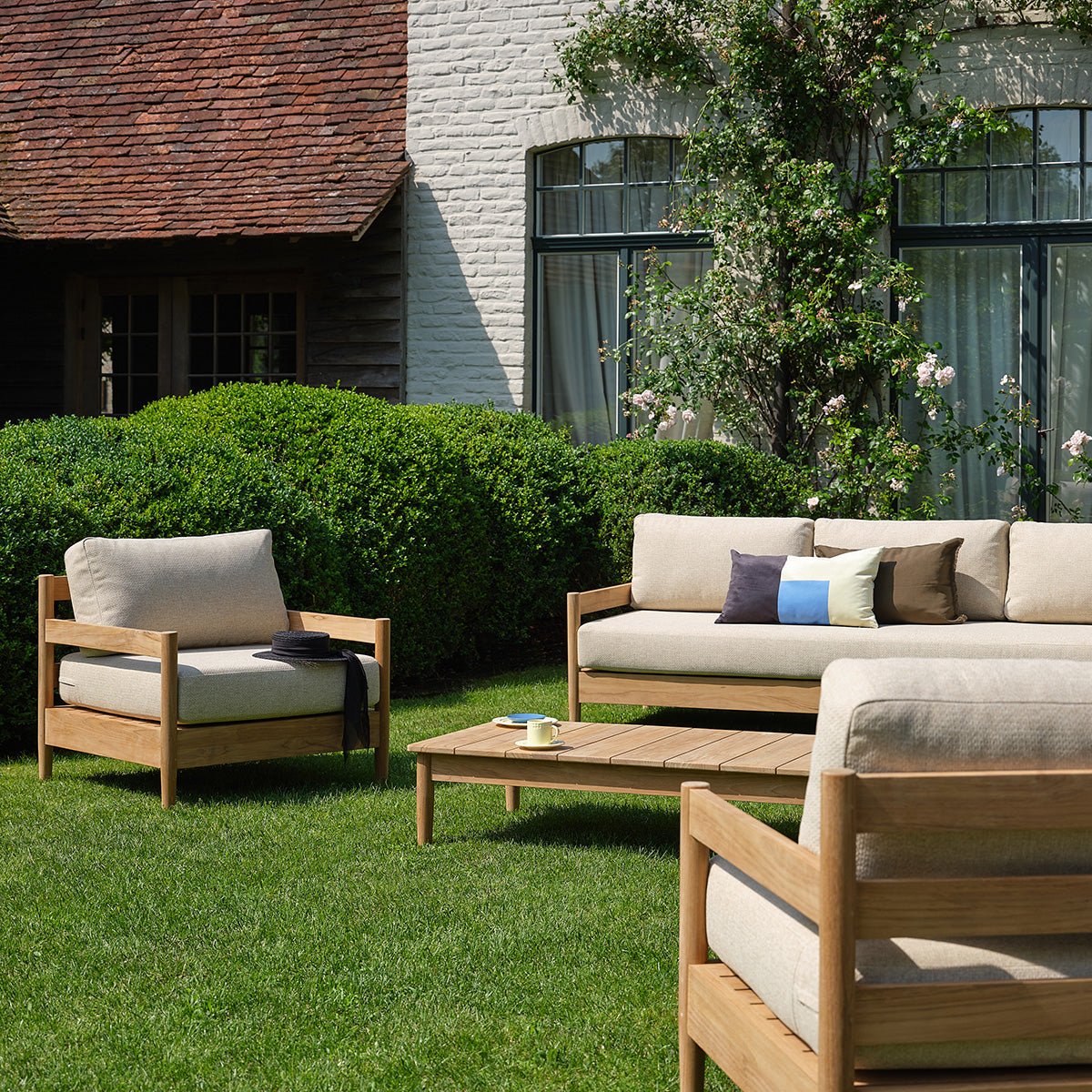 CALVI - Fauteuil de jardin bas en teck massif avec coussins beige chiné